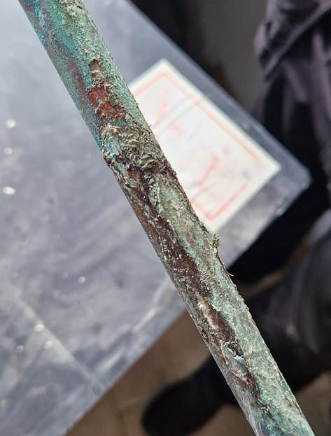 Close-up of corrosion on a copper pipe